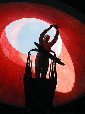 Muralist John Anderson at work on the red skylight mural.